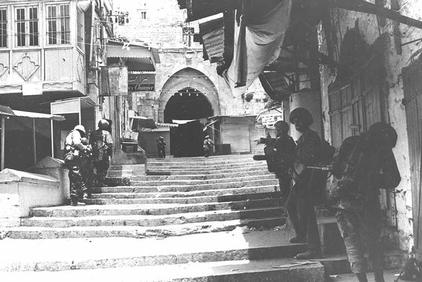 Six Day War. Israeli paratrooper unit advances through a deserted lane in the Old City of Jerusalem. -GPO 06/07/1967