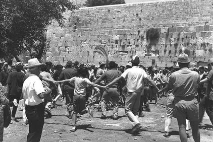 Group of young Israelis dancing the Hora in front of the Wailing Wall in Jerusalem after the unification of the Jerusalem . -GPO 07/02/1967